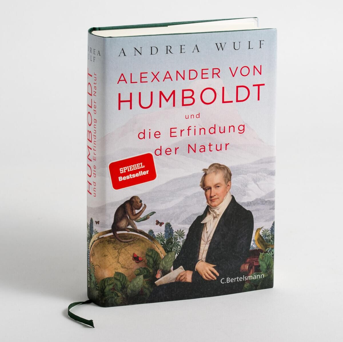 Das Bild zeigt das Buch 'Alexander von Humboldt und die Erfindung der Natur' von Andrea Wulf. Das Cover des Buches zeigt ein Porträt von Alexander von Humboldt, umgeben von Natur- und Tiermotiven. Das Buch hat einen grünen Buchrücken und ein farbig illustriertes Cover.