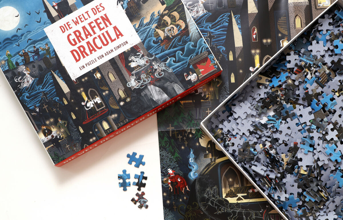 Bild eines Puzzles mit einer Abbildung von Draculas Schloss. Das Puzzle heißt 'Die Welt des Grafen Dracula'. Es zeigt ein gruseliges Schloss unter einem nächtlichen Himmel. Zerstreute Puzzleteile sind ebenfalls abgebildet. Die dominierenden Farben sind Schwarz, Blau, Rot, Weiß und Grau.