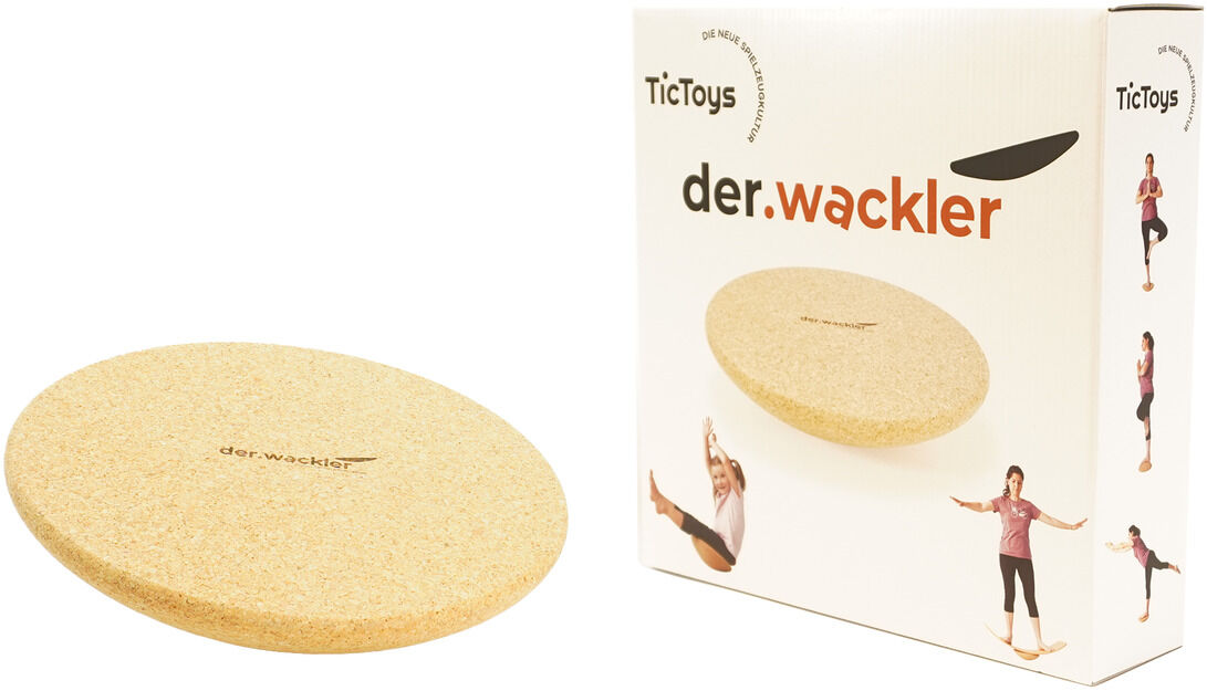 Ein Gleichgewichtstrainer aus Holz, bekannt als »Der Wackler«, neben seiner Verpackung. Das Gerät ist rund und beige, während die Verpackung weiß mit roten und schwarzen Details ist. Auf der Verpackung sind Bilder von Menschen, die das Gerät benutzen, abgebildet.