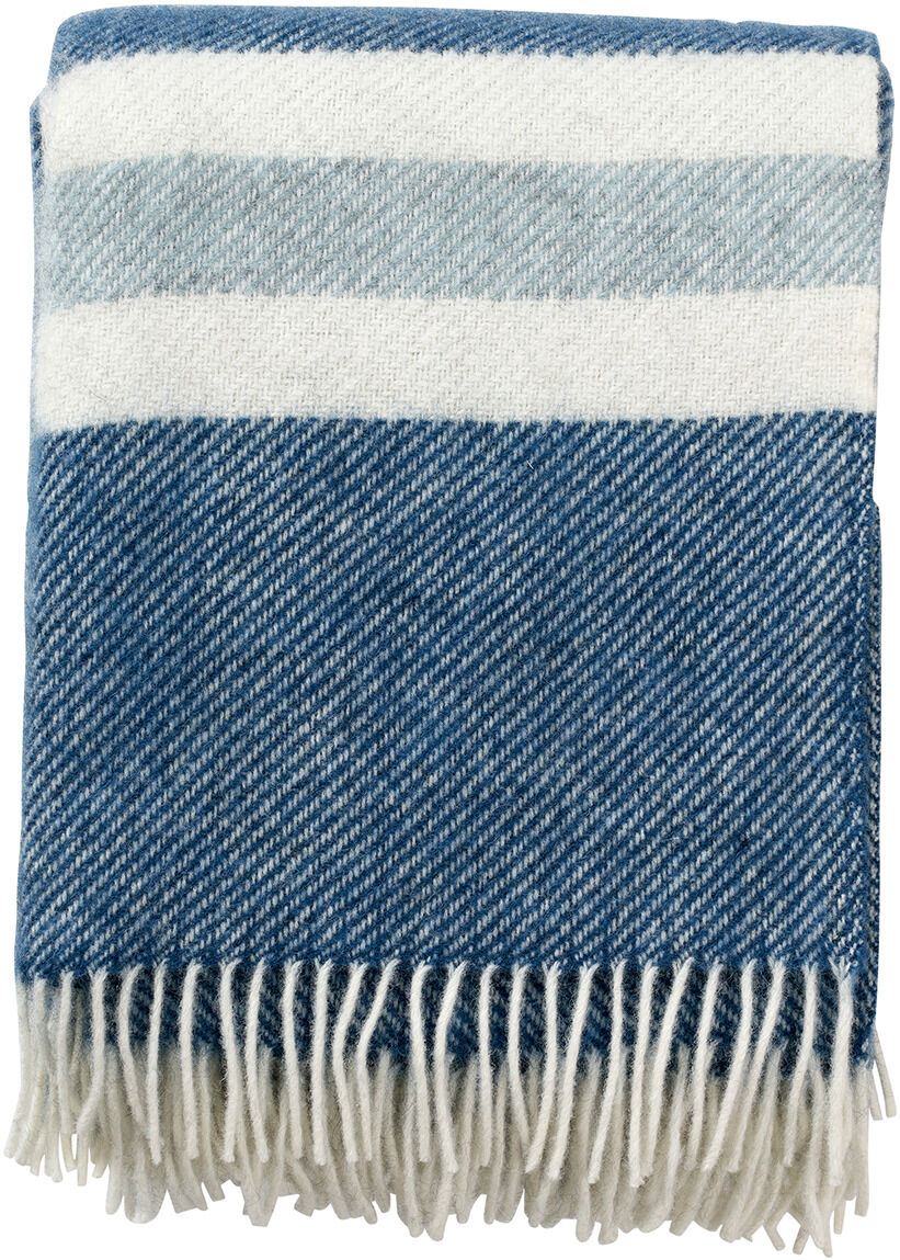 Die Decke »Gotland Stripe« zeigt ein gestreiftes Muster in Blau, Weiß und Grau mit dekorativen Fransen. Ideal für gemütliche Winterabende oder als stilvolle Ergänzung für das Wohnzimmer.