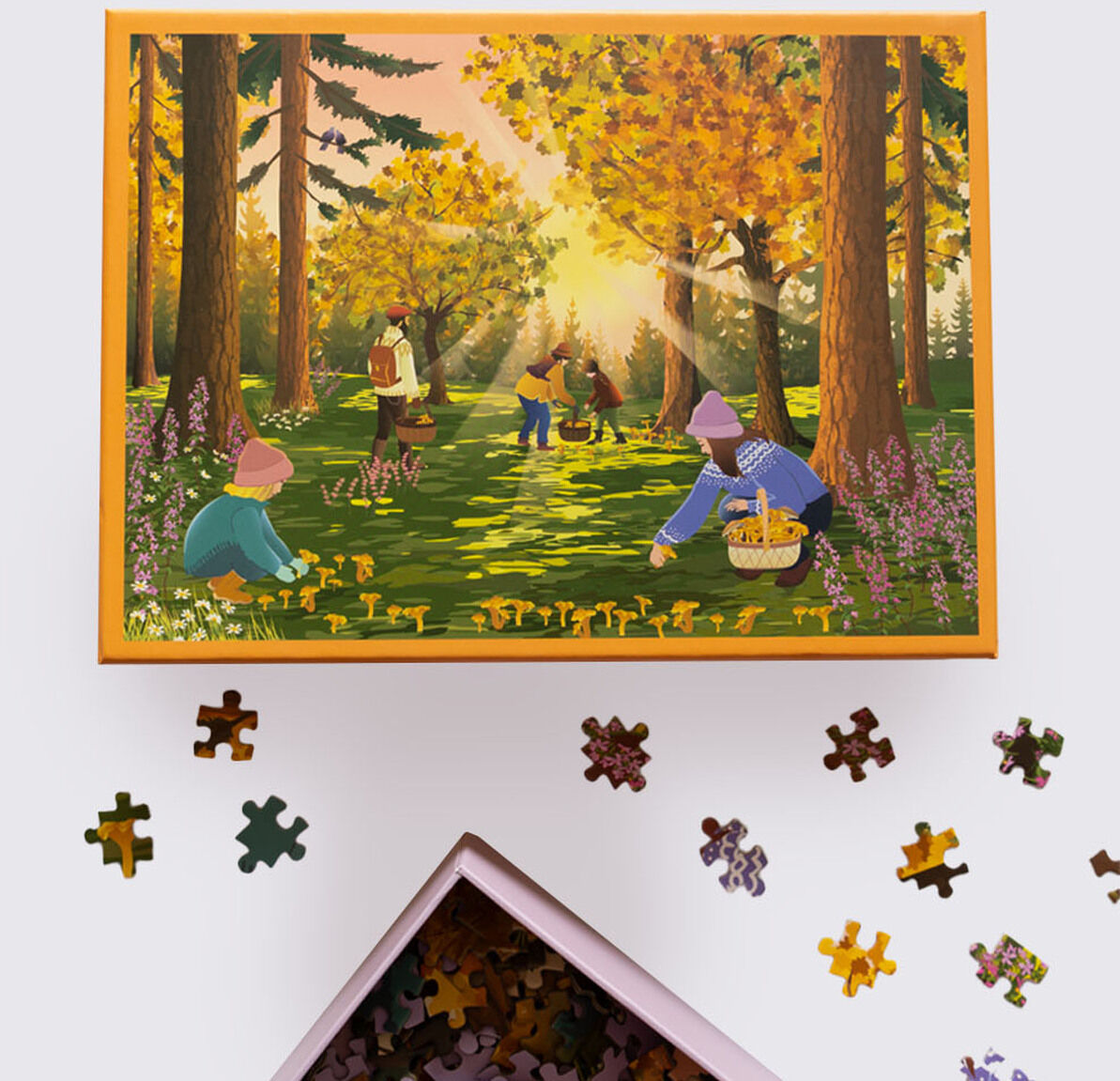 Illustration auf einer Puzzelschachtel mit einer Szene im herbstlichen Wald, in der Kinder und Erwachsene Pilze sammeln, umgeben von buntem Laub und Lichtstrahlen zwischen Bäumen. Vor der Schachtel liegen Puzzleteile, einige Teile setzen das Waldbild und herbstliche Farben fort.