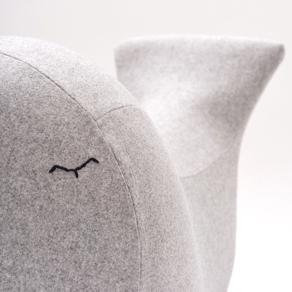 Ein elegantes Spielzeug in der Form eines Wals. Es besteht aus filzartigem Material in einem minimalistischen grauen Design. Ideal für Kinderzimmer als Schaukel und Dekorationsobjekt.