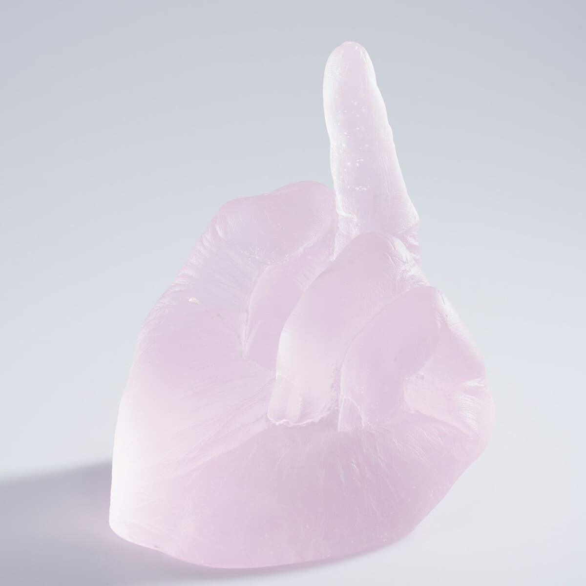Eine hellrosa und transparente Glasplastik von Ai Weiwei mit dem Titel »Study of Perspective in Glass«, die eine Hand zeigt, welche den Mittelfinger erhebt.