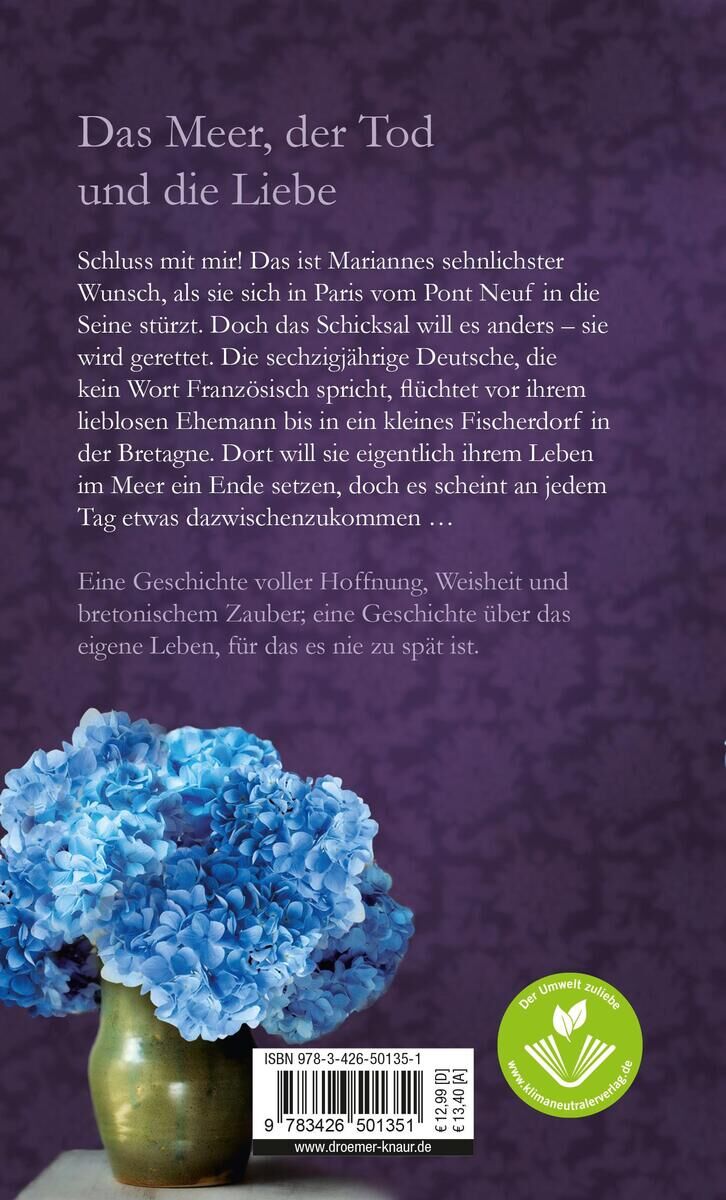 Rückseite eines Buches mit dem Titel 'Das Meer, der Tod und die Liebe'. Im unteren Teil des Covers befindet sich ein Bild von blauen Hortensien vor einem lila Hintergrund. Rechts unten ist ein grünes Siegel mit einem Blattdruck. Oben stehen in weißer Schrift Beschreibungstexte zum Buch.